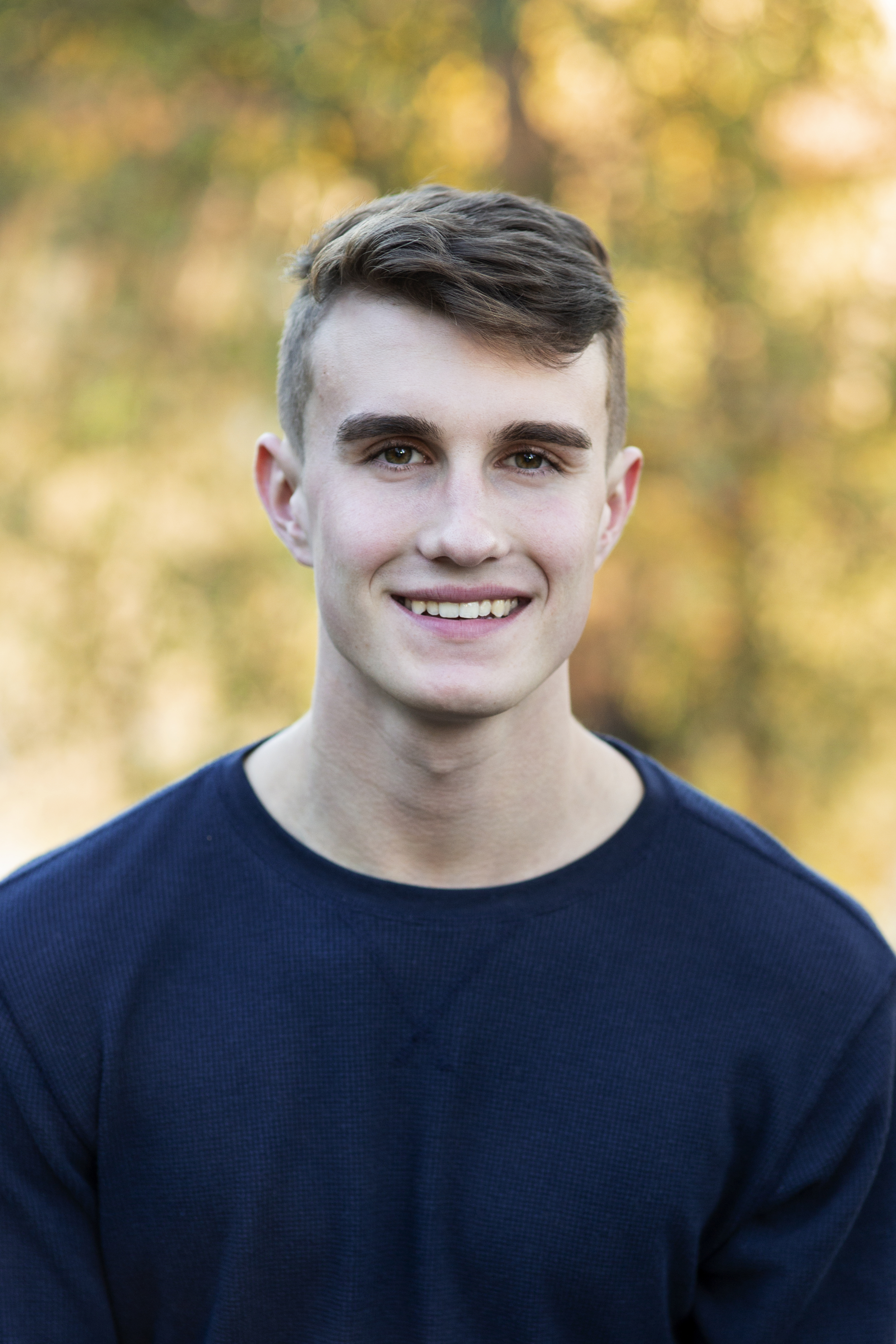 senior guy portrait headshot at golden hour with bokeh